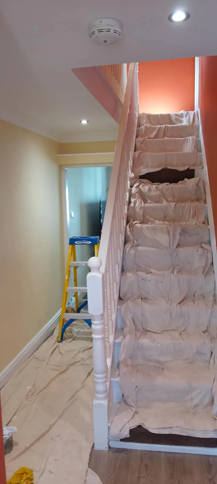 a painted staircase and hallway, with red walls
